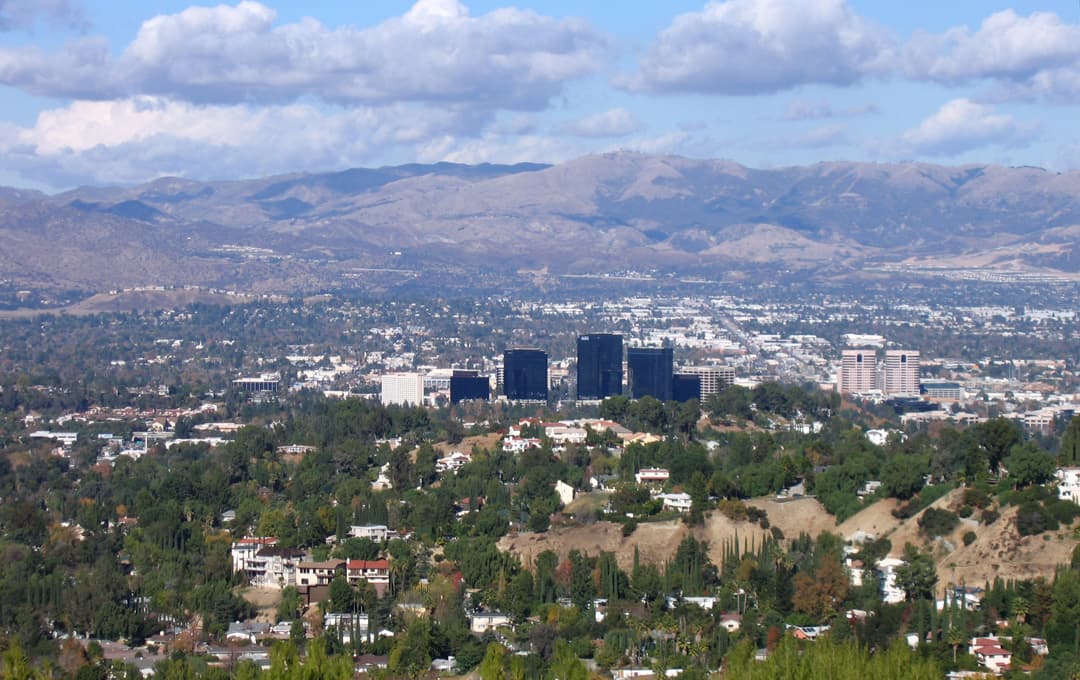 The San Fernando Valley seen from the Santa Monica Mountains, with Woodland Hills and the Warner Center towers in the foreground.